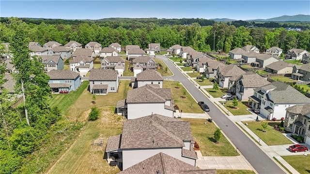 bird's eye view featuring a wooded view and a residential view