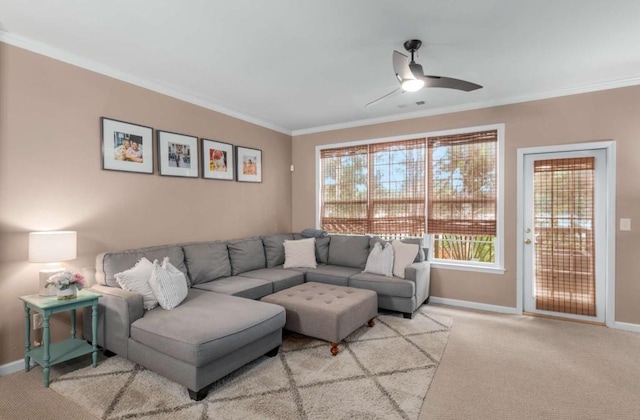 carpeted living room with ceiling fan and crown molding