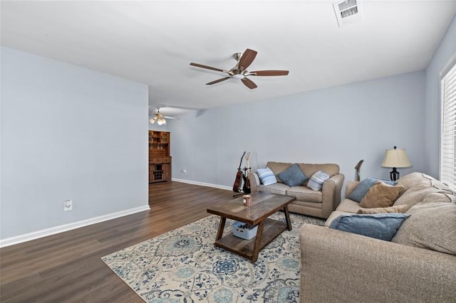 living room with dark hardwood / wood-style floors and ceiling fan