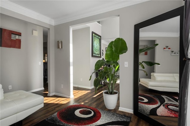 living room featuring crown molding, baseboards, and wood finished floors