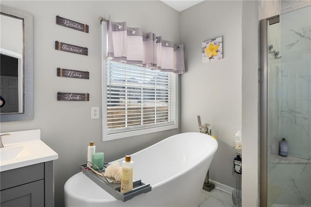 full bathroom with vanity, baseboards, a soaking tub, a shower stall, and marble finish floor