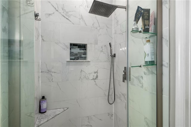 bathroom with a marble finish shower