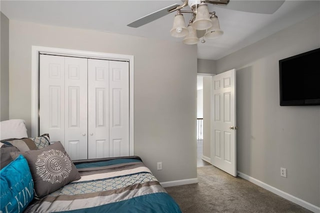 carpeted bedroom featuring baseboards, a closet, and ceiling fan