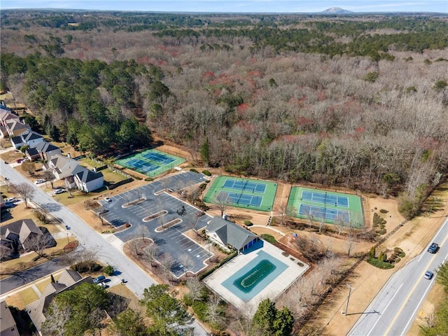 birds eye view of property with a wooded view