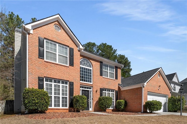 traditional home featuring concrete driveway, brick siding, and a garage