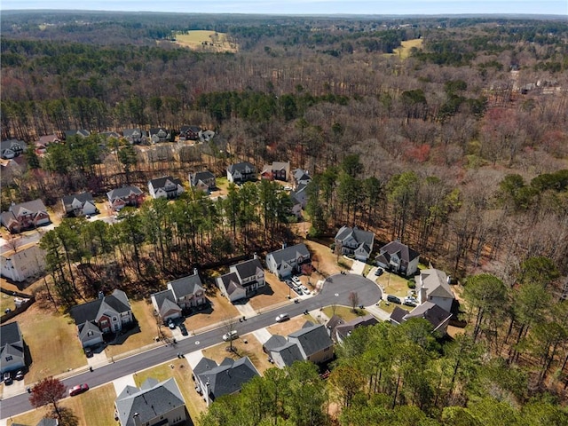 drone / aerial view featuring a view of trees and a residential view