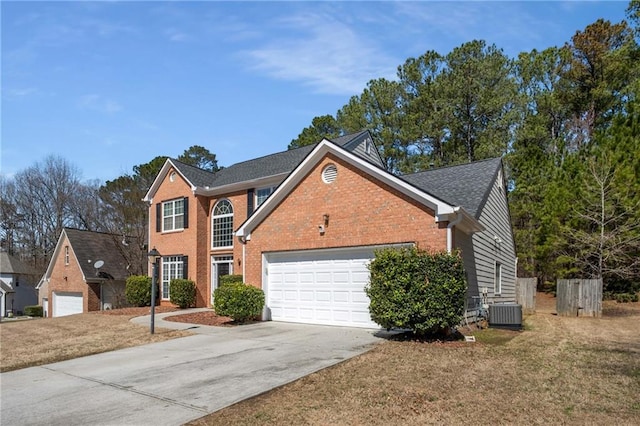 view of front of house with brick siding, cooling unit, an attached garage, and concrete driveway