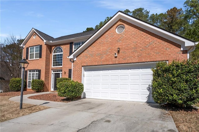 view of front of home featuring brick siding, an attached garage, and concrete driveway