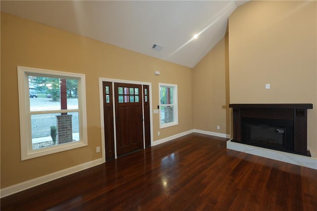 foyer with vaulted ceiling and dark hardwood / wood-style flooring