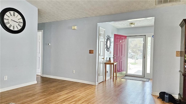 2233 Hansford Pass, Buford, GA 30519 - entryway featuring wood finished floors and a textured ceiling