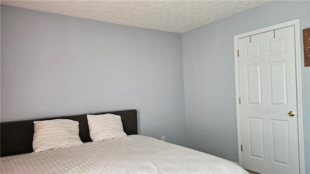 2233 Hansford Pass, Buford, GA 30519 - bedroom with a textured ceiling