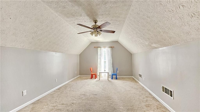 2233 Hansford Pass, Buford, GA 30519 - additional living space featuring a textured ceiling, vaulted ceiling, carpet, and ceiling fan