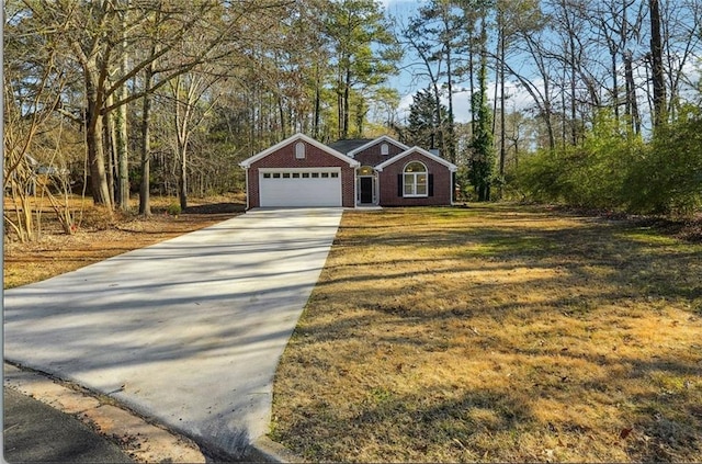 view of front facade with a front yard, brick siding, driveway, and an attached garage