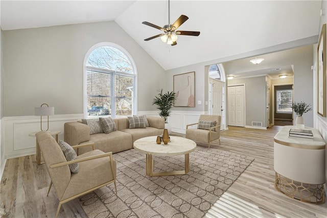 20 Trace Ct, Covington, GA 30016 - living room with light wood-style floors, ceiling fan, a decorative wall, a wainscoted wall, and high vaulted ceiling
