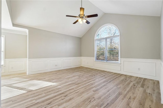 20 Trace Ct, Covington, GA 30016 - unfurnished room featuring wainscoting, a ceiling fan, lofted ceiling, light wood-type flooring, and a decorative wall