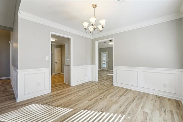 20 Trace Ct, Covington, GA 30016 - unfurnished dining area featuring a chandelier, light wood-style floors, ornamental molding, a ceiling fan, and a wainscoted wall