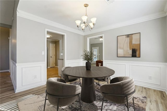20 Trace Ct, Covington, GA 30016 - dining area featuring a chandelier, wood finished floors, crown molding, a wainscoted wall, and ceiling fan