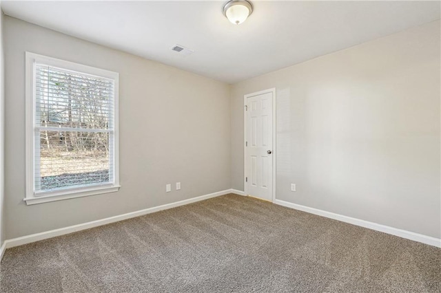 carpeted empty room with baseboards and visible vents