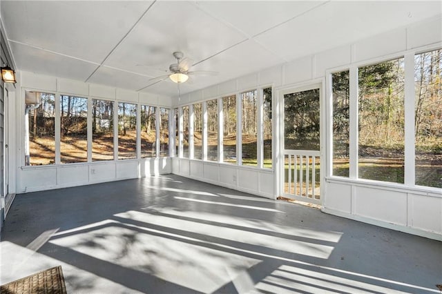 unfurnished sunroom featuring a ceiling fan