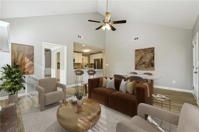 20 Trace Ct, Covington, GA 30016 - living area with light wood-style flooring, ceiling fan, high vaulted ceiling, and baseboards