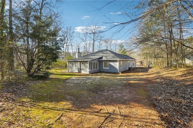 20 Trace Ct, Covington, GA 30016 - view of home's exterior with a sunroom and a chimney
