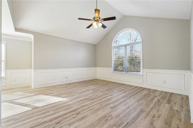 spare room with light wood-type flooring, visible vents, a ceiling fan, and lofted ceiling