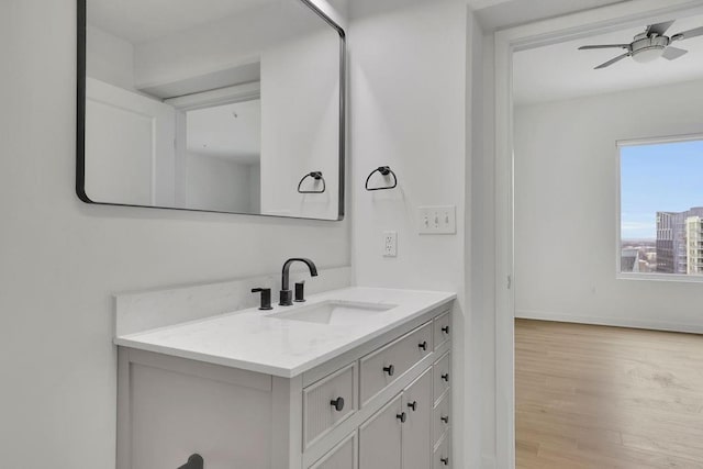 bathroom with hardwood / wood-style flooring, vanity, and ceiling fan