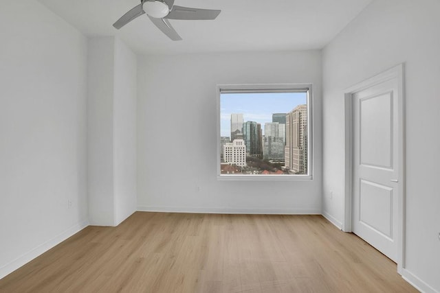 empty room featuring light hardwood / wood-style floors and ceiling fan