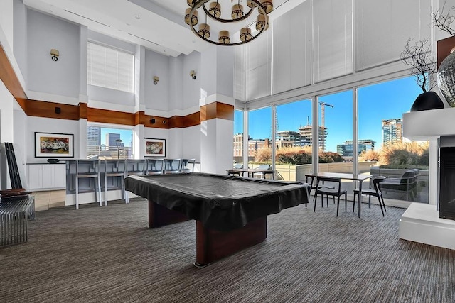 playroom featuring radiator, a towering ceiling, pool table, and dark colored carpet