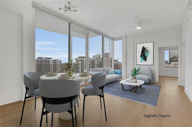 dining area featuring floor to ceiling windows, hardwood / wood-style floors, and a wealth of natural light