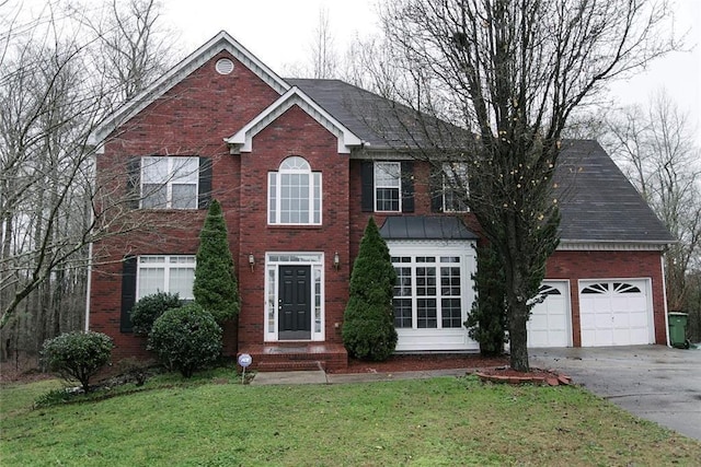 view of front of house featuring a front yard and a garage