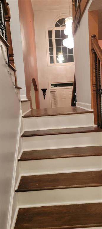 staircase with hardwood / wood-style flooring