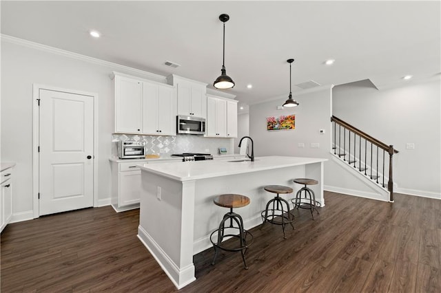 6240 Merrill View Ln, Alpharetta, GA 30004 - kitchen featuring an island with sink and white cabinets