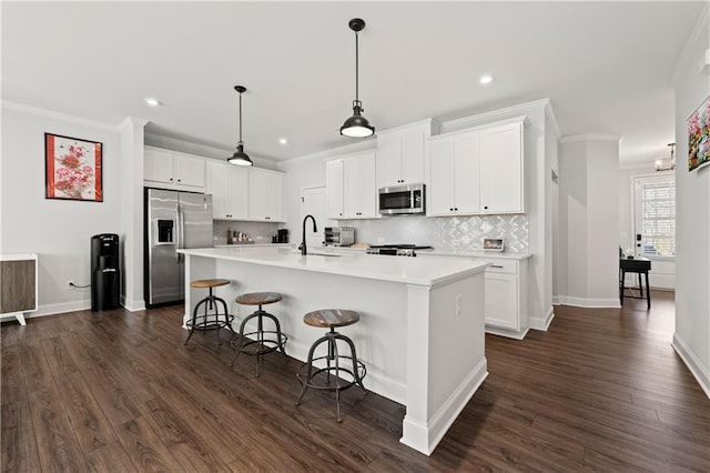 6240 Merrill View Ln, Alpharetta, GA 30004 - kitchen with a center island with sink, hanging light fixtures, stainless steel appliances, white cabinets, and crown molding