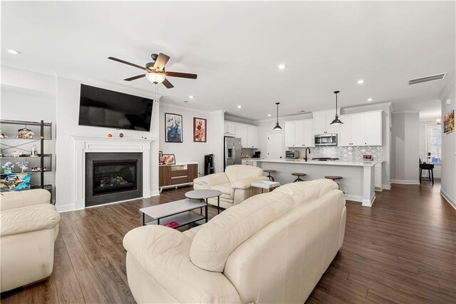 6240 Merrill View Ln, Alpharetta, GA 30004 - living room with sink, ceiling fan, dark wood-type flooring, and crown molding