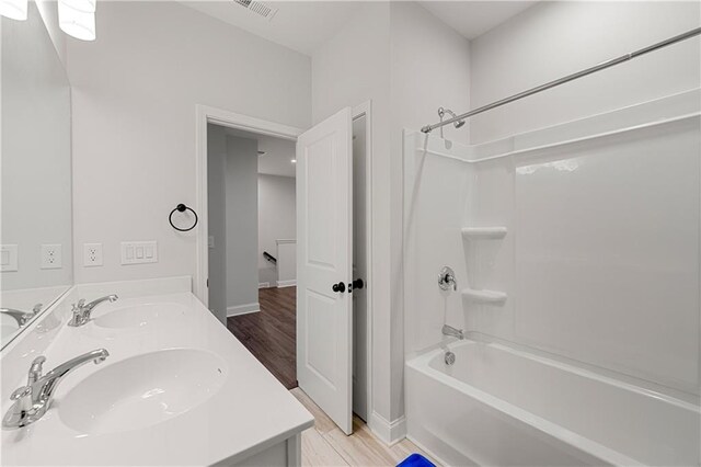 6240 Merrill View Ln, Alpharetta, GA 30004 - bathroom featuring wood-type flooring, vanity, and shower / bathtub combination
