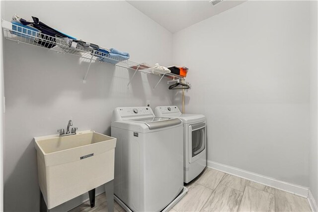 6240 Merrill View Ln, Alpharetta, GA 30004 - laundry room with sink and washer and clothes dryer