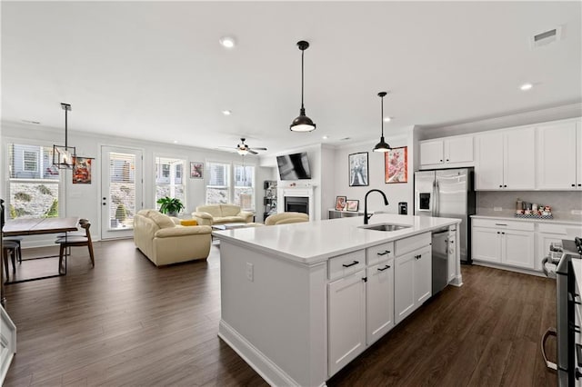 6240 Merrill View Ln, Alpharetta, GA 30004 - kitchen with white cabinets, an island with sink, appliances with stainless steel finishes, and sink