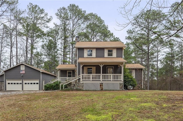 view of front of property featuring an outbuilding, a front yard, a porch, and a garage