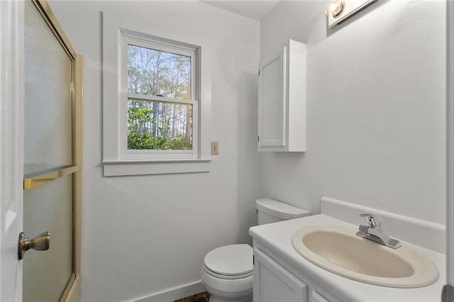 bathroom featuring walk in shower, vanity, and toilet