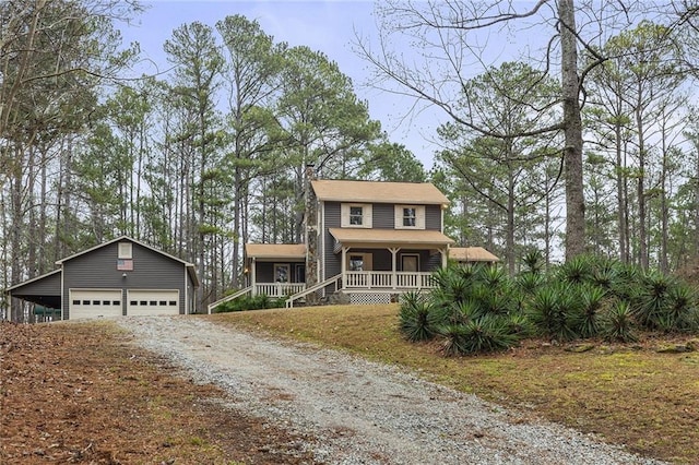 view of front of house featuring an outbuilding, a porch, and a garage