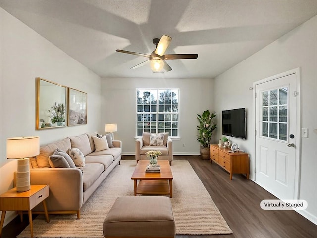 living room with a ceiling fan, plenty of natural light, baseboards, and wood finished floors