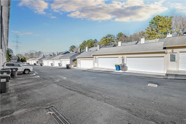 view of street featuring a residential view and community garages