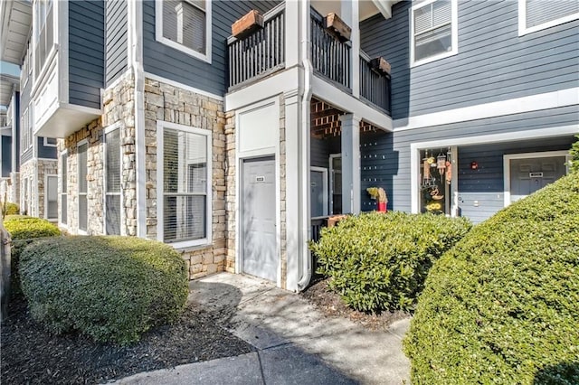 property entrance with stone siding