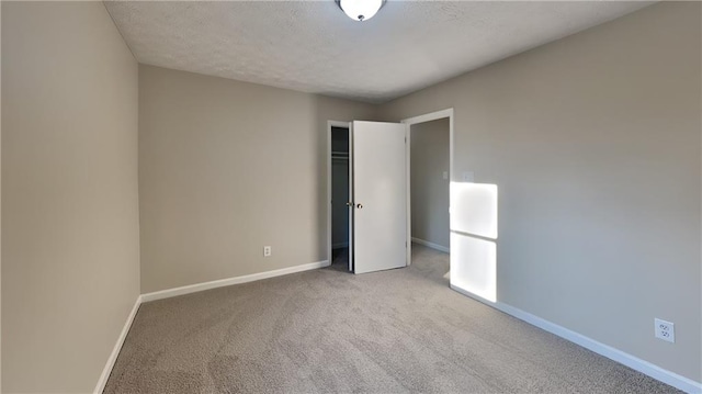 unfurnished bedroom featuring carpet and a textured ceiling