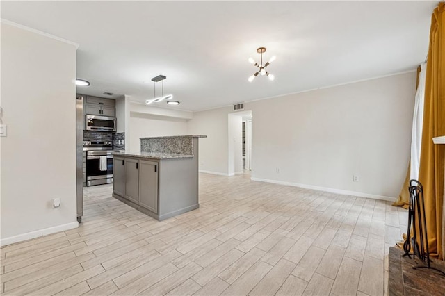 kitchen with gray cabinets, appliances with stainless steel finishes, light hardwood / wood-style floors, and decorative light fixtures