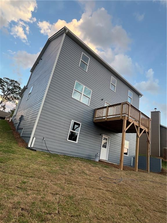 rear view of house with a yard