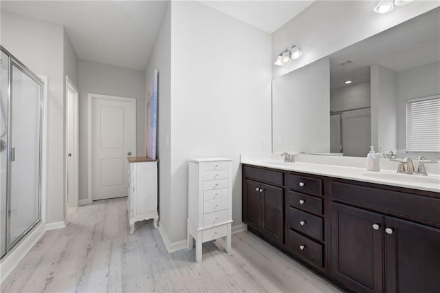 full bath featuring a shower stall and a sink