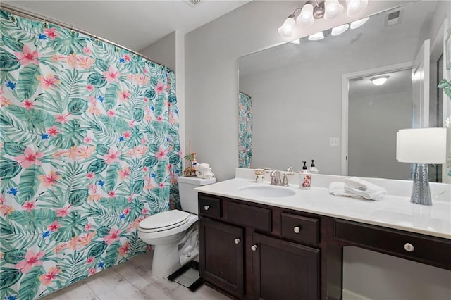 full bath featuring visible vents, toilet, and vanity