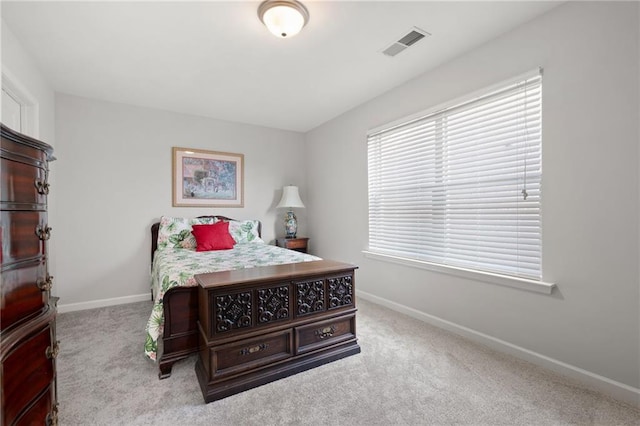 carpeted bedroom featuring visible vents and baseboards